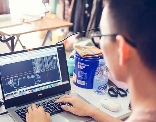 Engineers using digital tools at a construction site with real estate IT solutions.